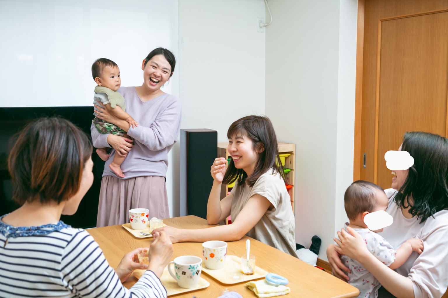 赤ちゃんを抱きながら、参加したママたちと話す戸田まいこ